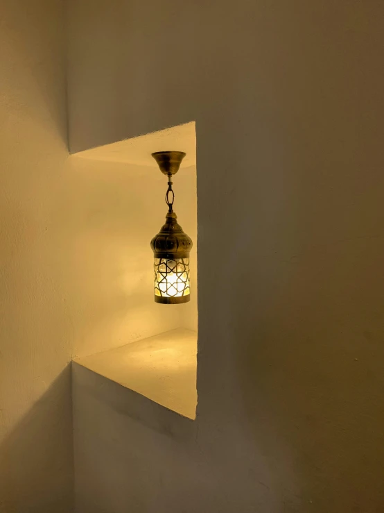 a lantern light shines in the corner of a room