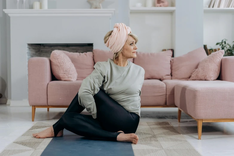 a woman meditating while sitting on the floor