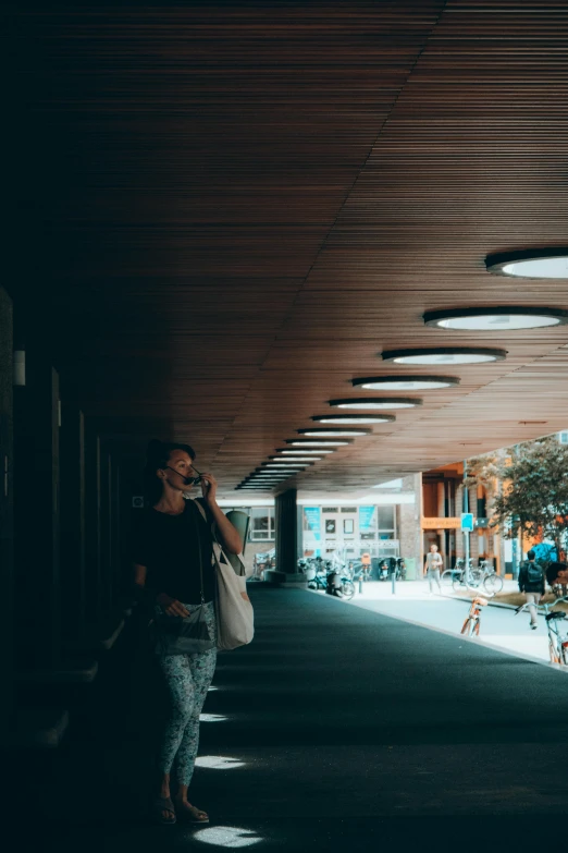 a woman in a parking garage talking on her cell phone