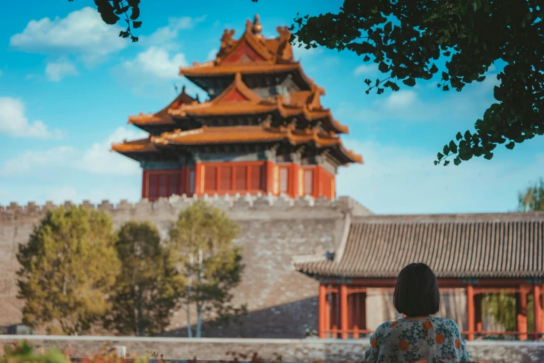 a woman looking at the asian style architecture