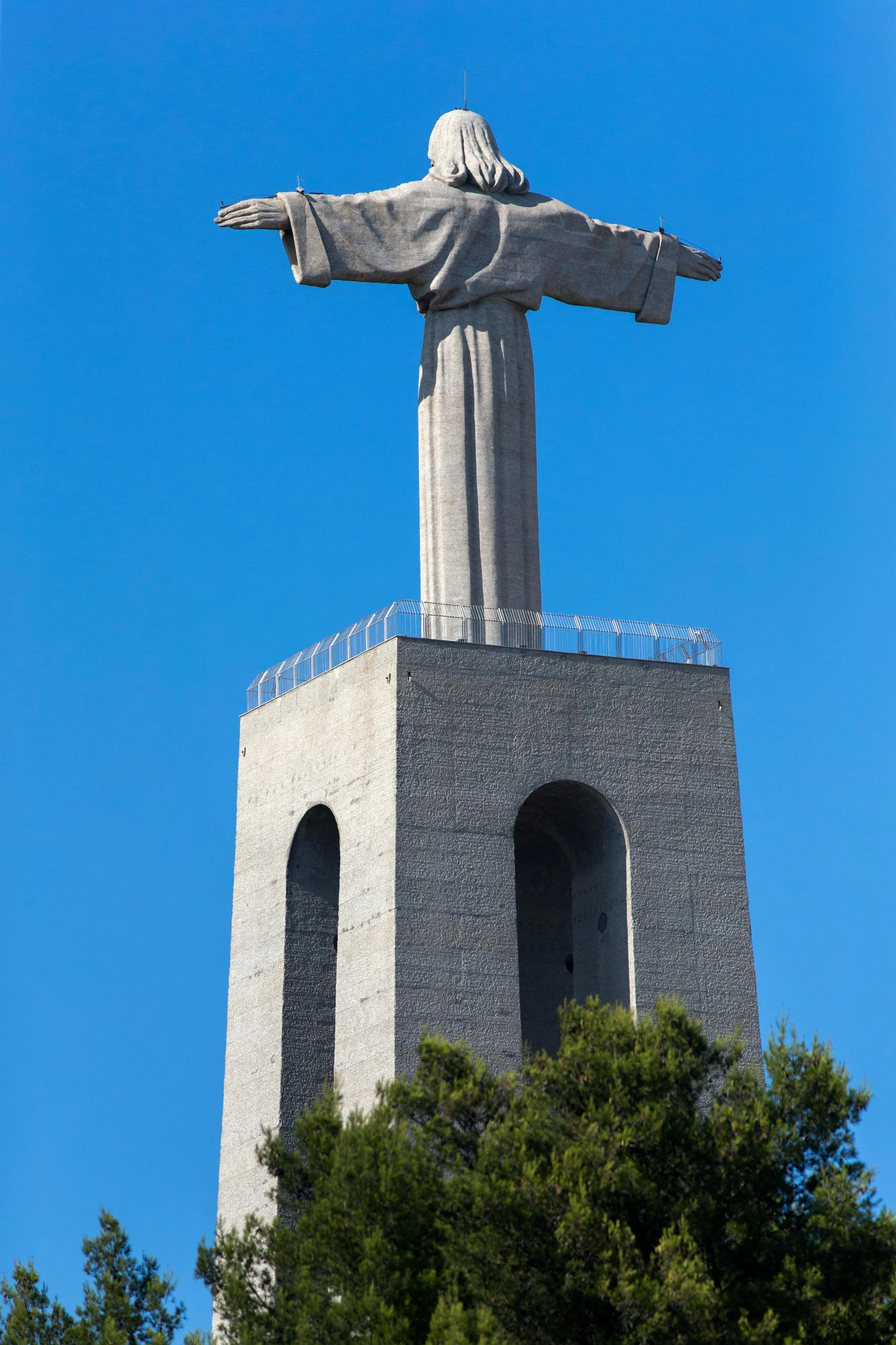 a monument made of stone with a statue standing on top