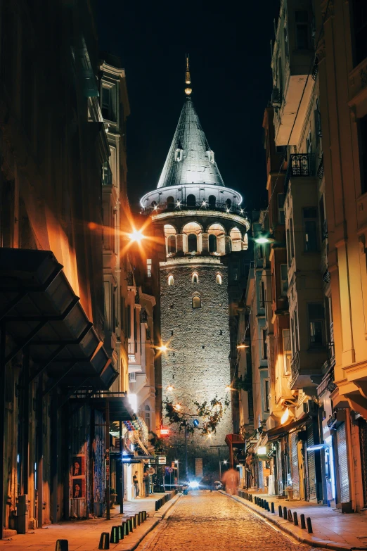 an alleyway leading to a tower in a city