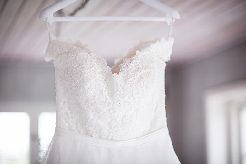 wedding dress on display in white room at winery