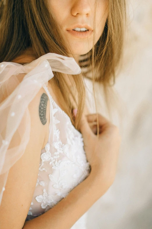 young woman in white dress posing for pograph