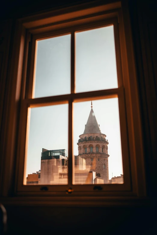 a view of a clock tower from an open window