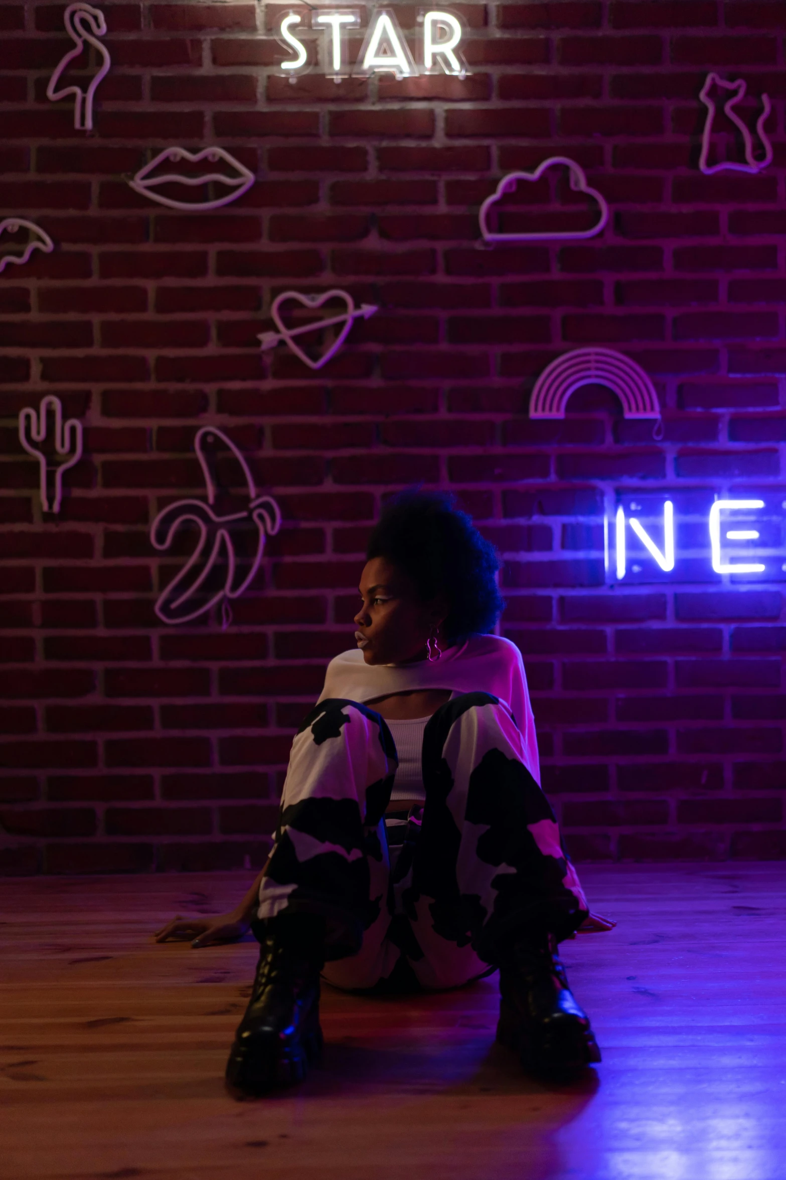 a girl is sitting in a dimly lit room