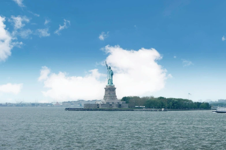 a small boat on the water near the statue of liberty