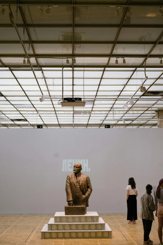 two sculptures of men and women at an art gallery