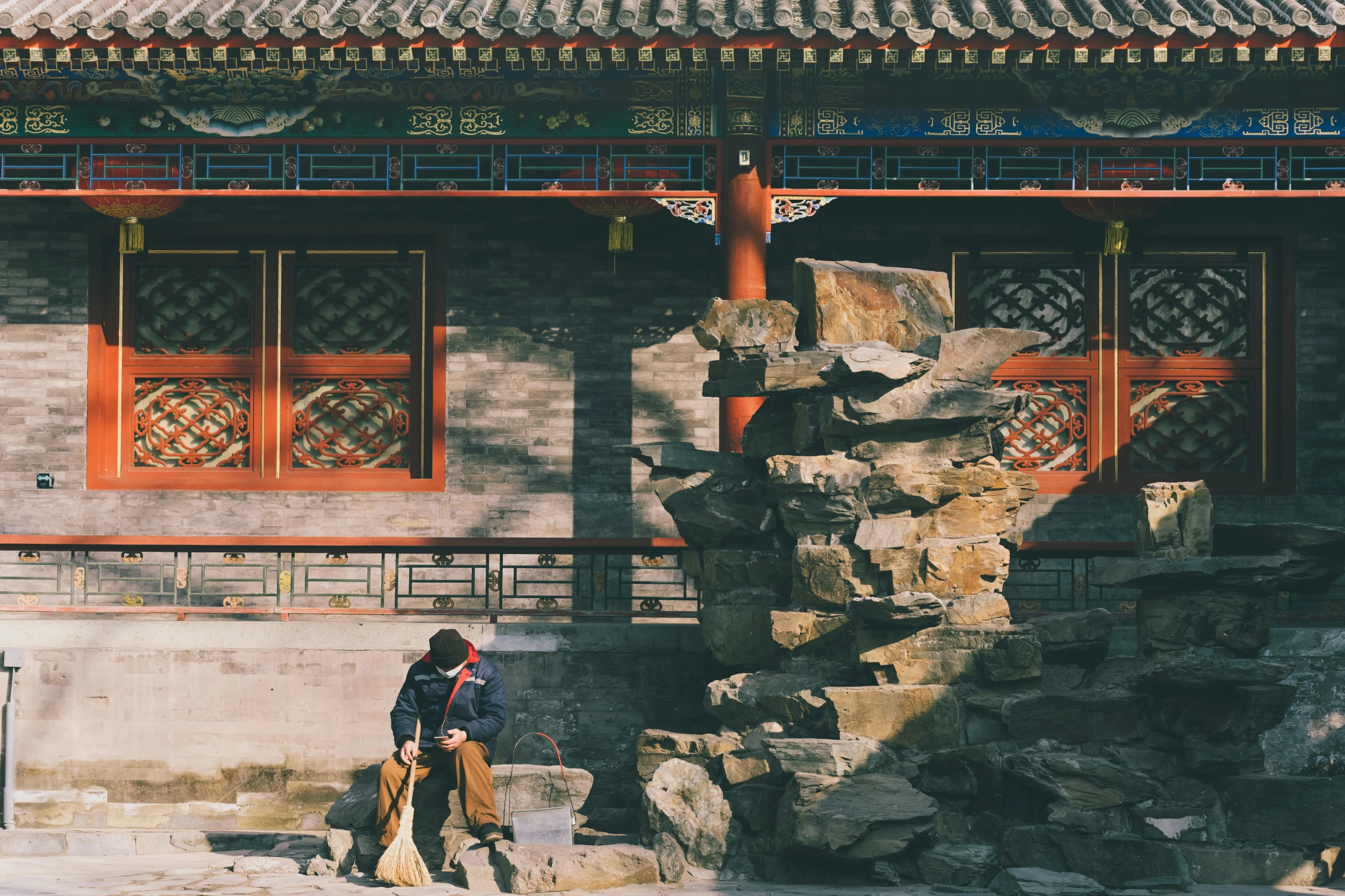 a woman standing next to a stone structure