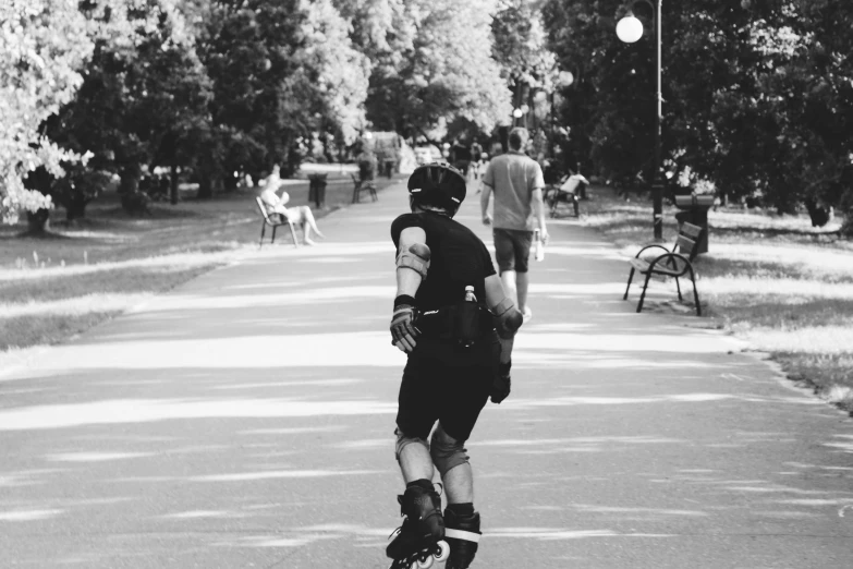 a person on a skateboard rides down a path