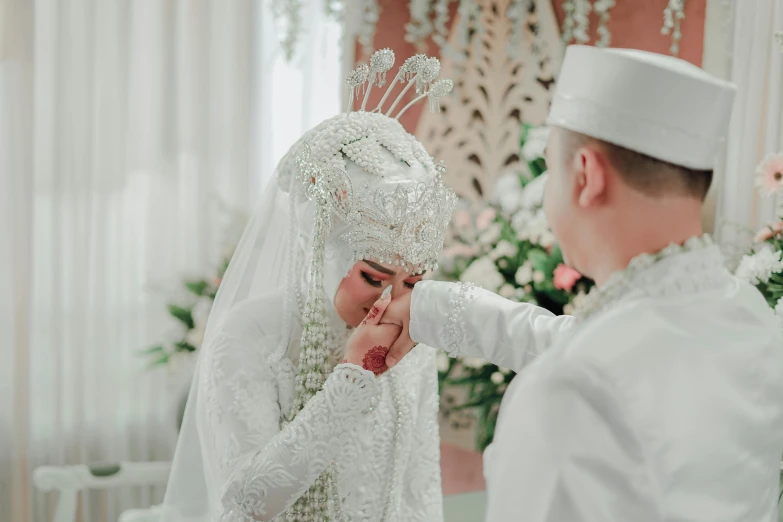 a woman is getting her groom's make up done