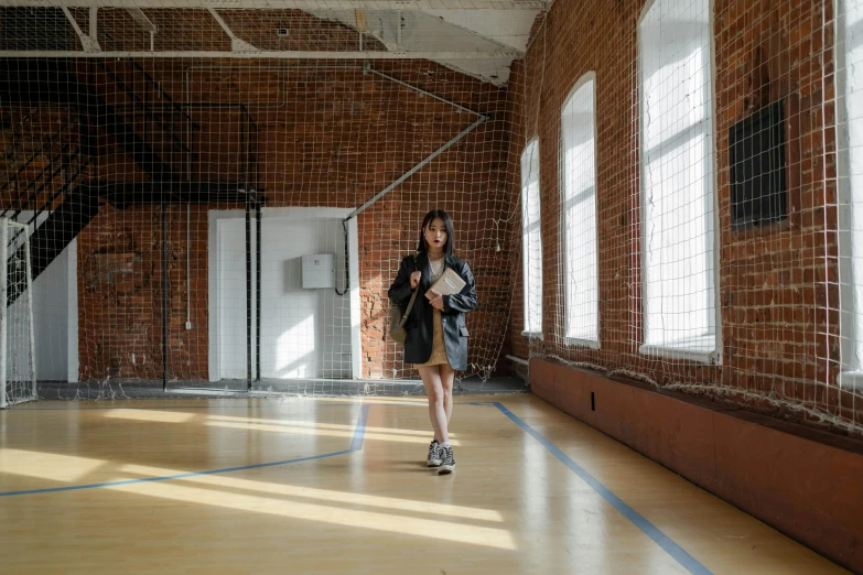 a person is walking in an empty building with bricks