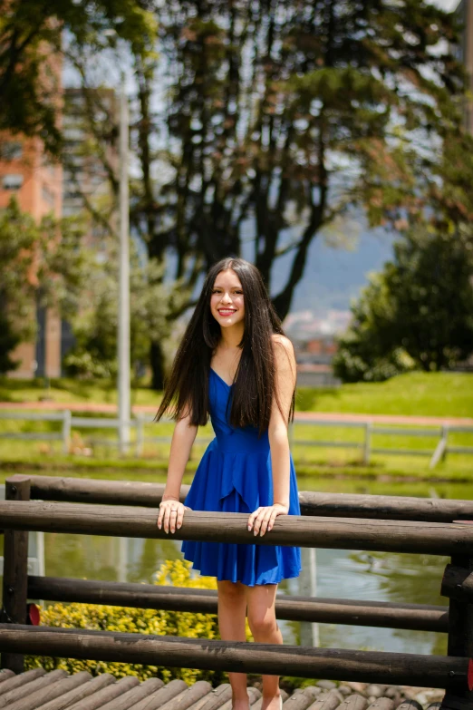 a woman leaning on a rail in the park