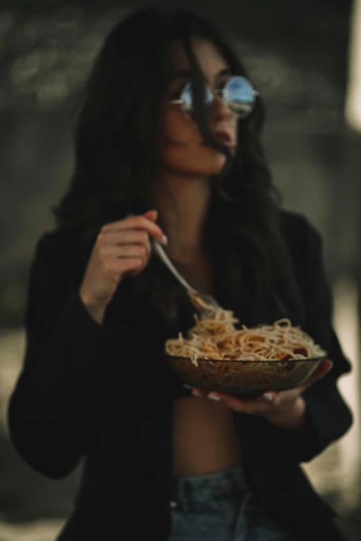 woman with large amount of spaghetti standing outdoors