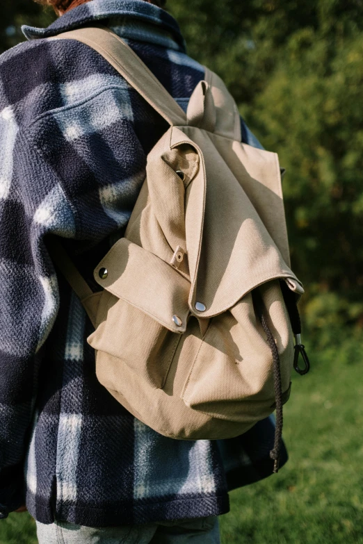 the back view of someone carrying a large bag in their back