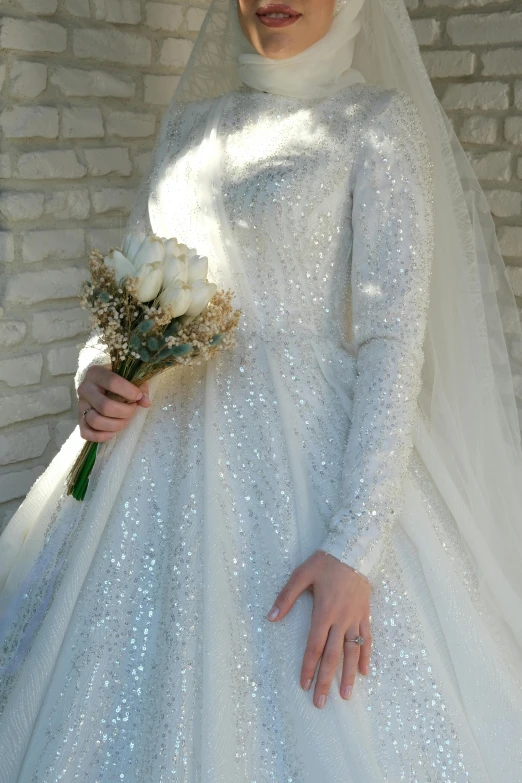 a woman wearing white holds a bouquet