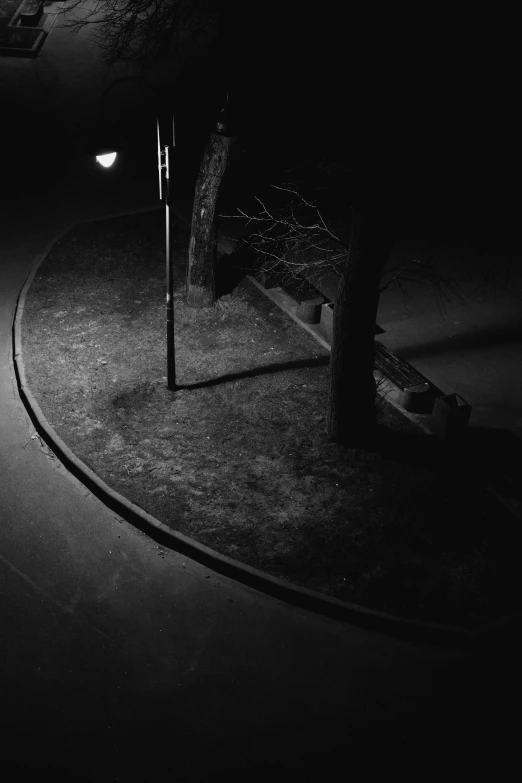 a bench on a street with an out of focus lamp