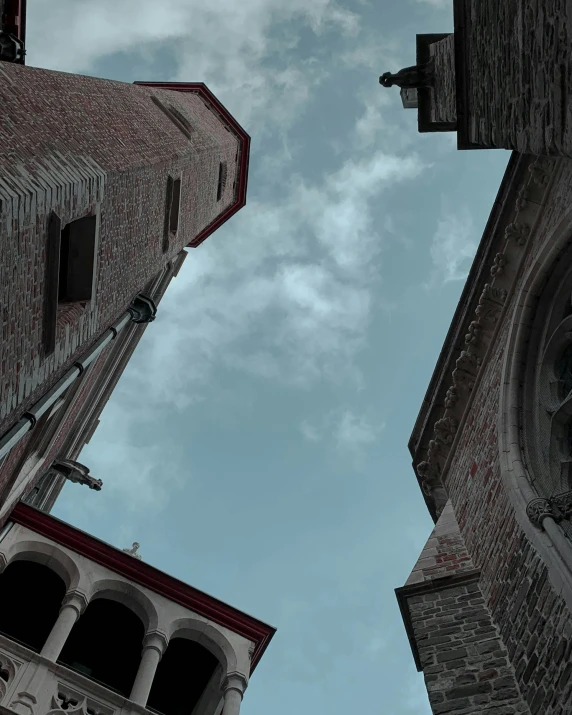 two buildings with very old windows and two spires