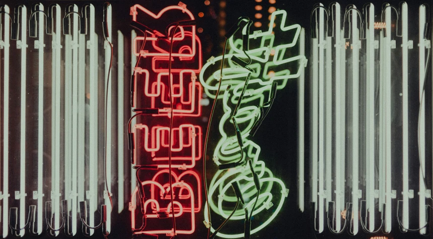 two neon signs hanging in front of a large window