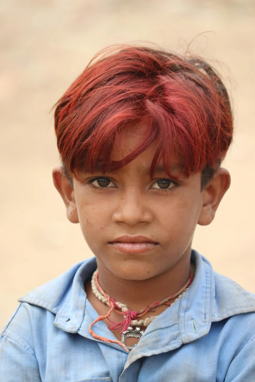 an indian girl with dyed red hair