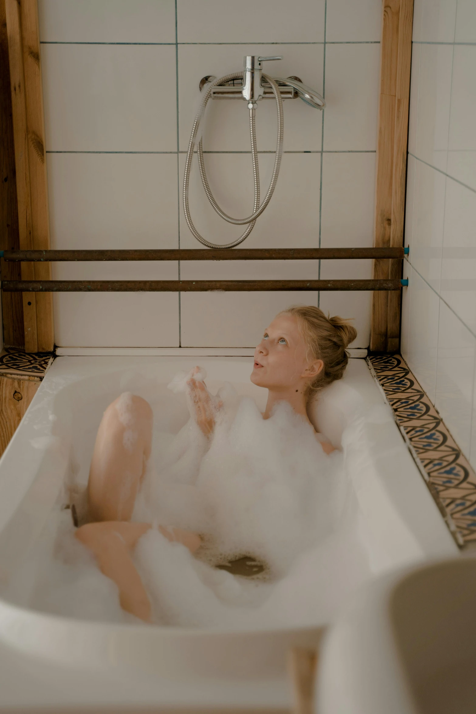 a woman that is laying down in the bath tub