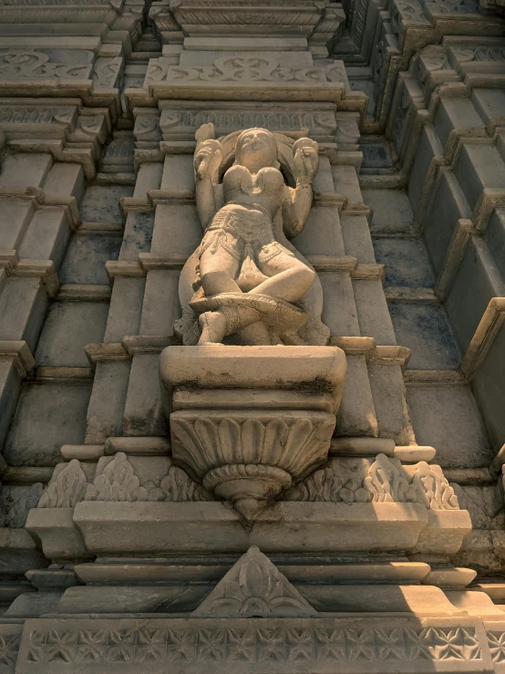 a statue of a man and a woman next to a building