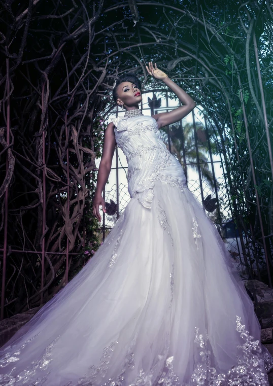 a beautiful bride standing under a green archway