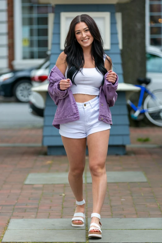 a pretty young lady walking down a street