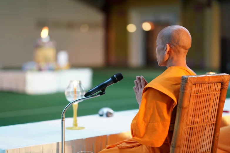 a man that is sitting in front of a microphone