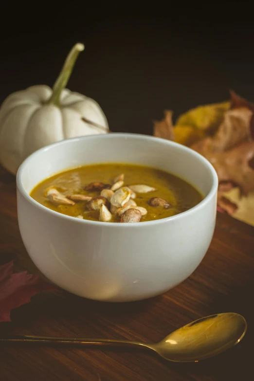 a bowl of pumpkin soup is sitting on the table