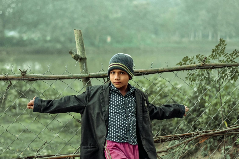 a boy on a fence posing for a po