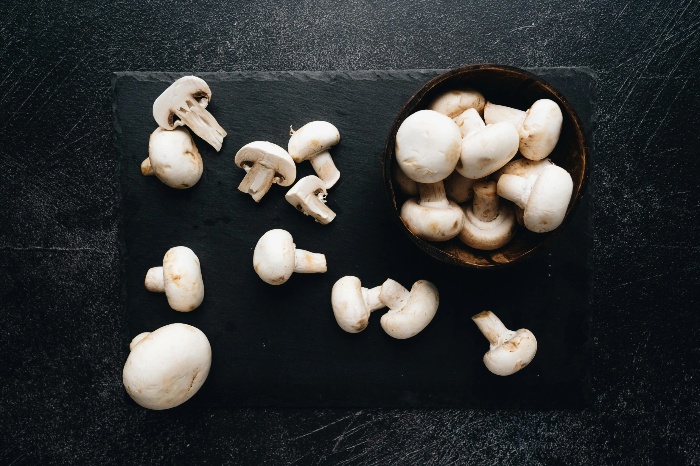 a group of mushrooms on a black surface