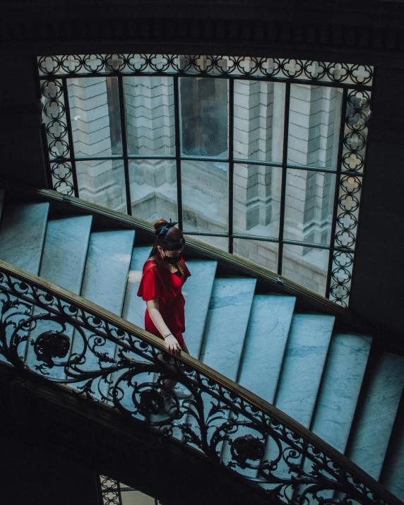 woman walking up stairs in an old building