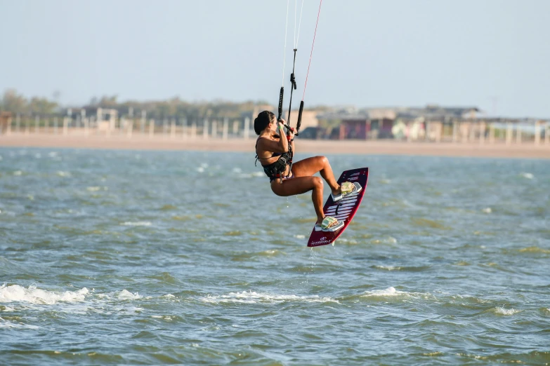 a girl is windsurfing through the water