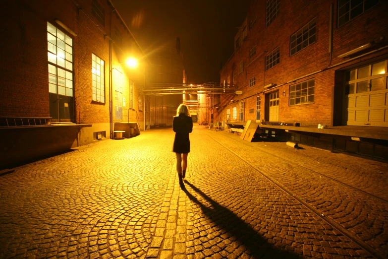 a woman walking alone in the city at night