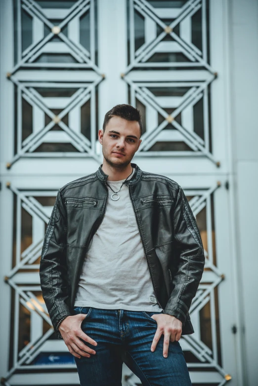 a man posing with his hands in his pockets