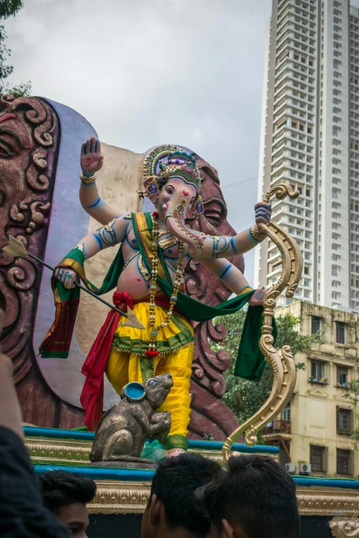 an elephant statue with two men in a parade