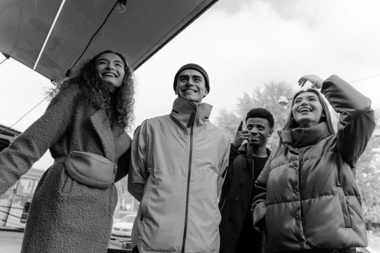 five people smile in front of a food tent