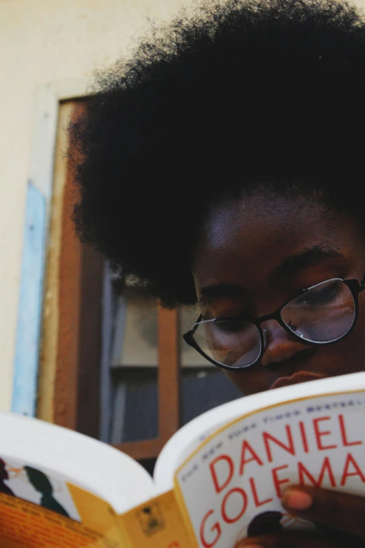 an african american woman reading a book about golema