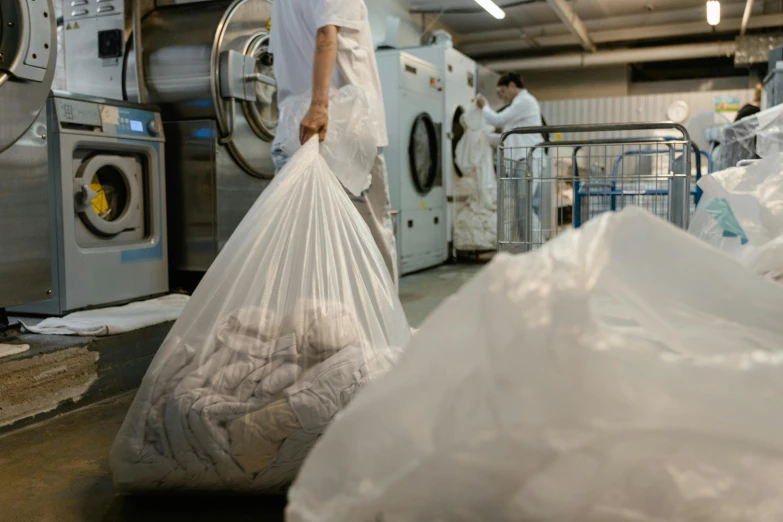 a man is putting some bags in a washing machine