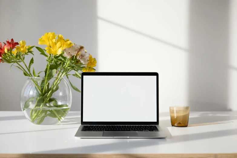 an open laptop sitting on top of a white table