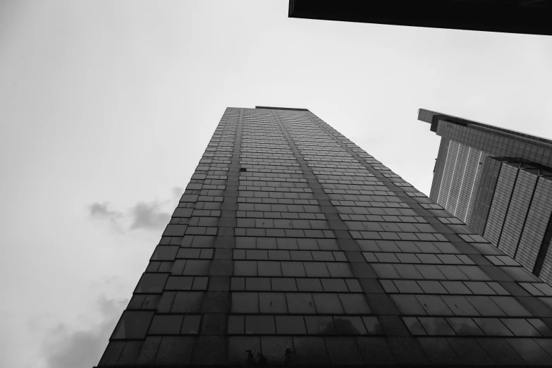 looking up into the sky at an upward view of a tall skyscr