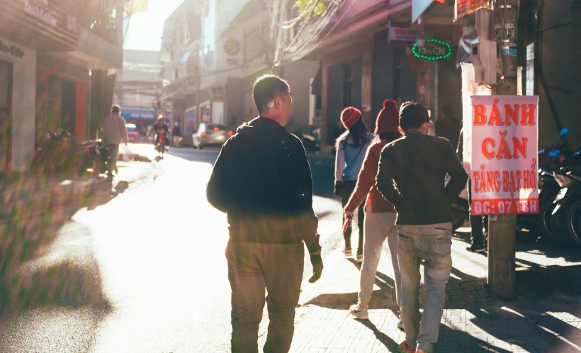 two men walking down the street near people