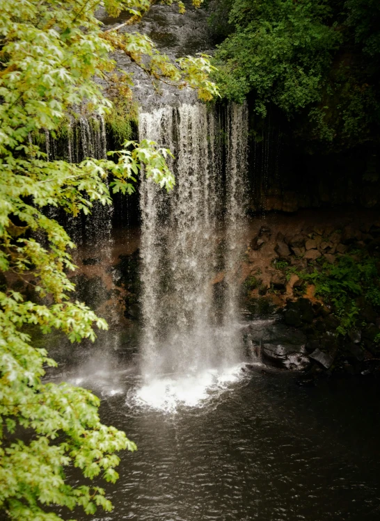 a large waterfall falling into a body of water