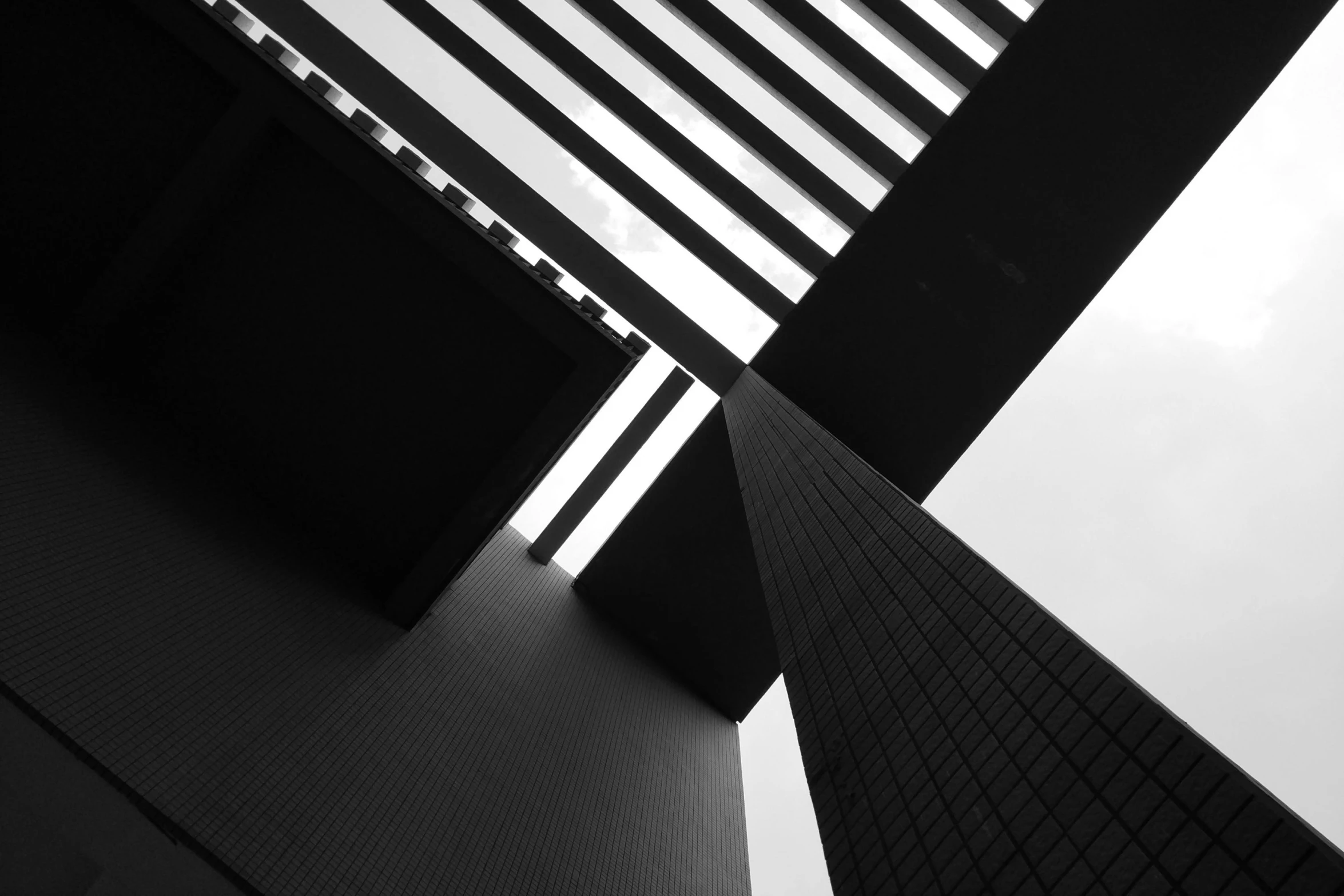 some tall buildings with a cloudy sky in the background