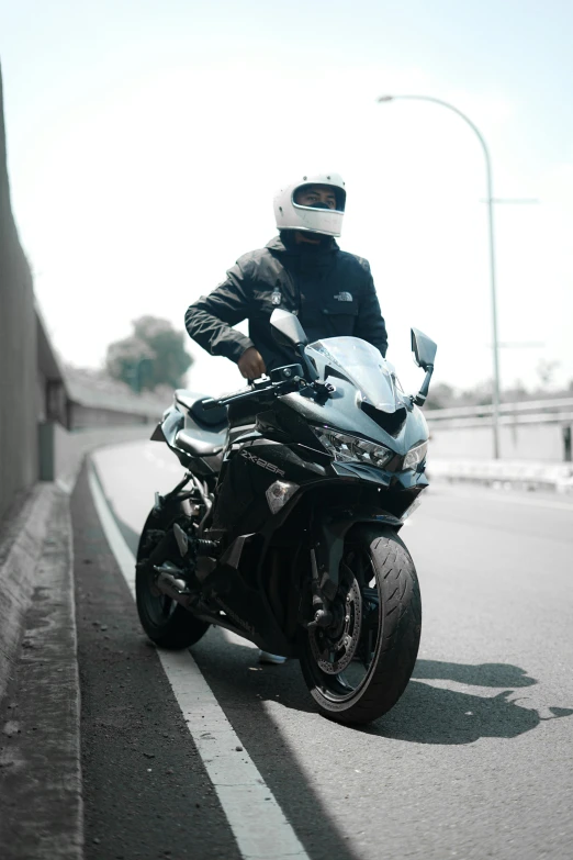 a person on a motorcycle rides down the street