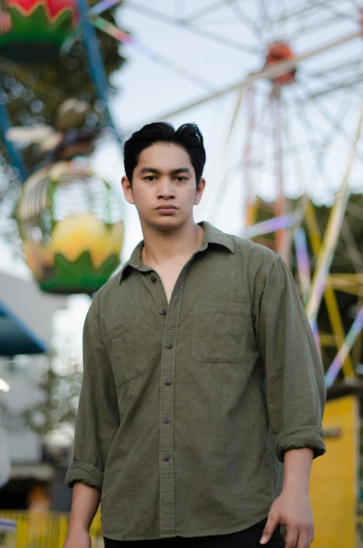 a man standing next to a carnival ride