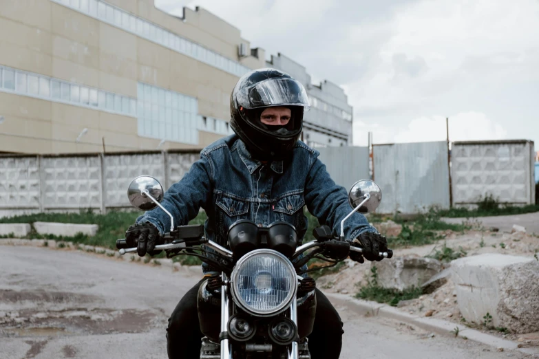 the man is riding his motorcycle on a country road