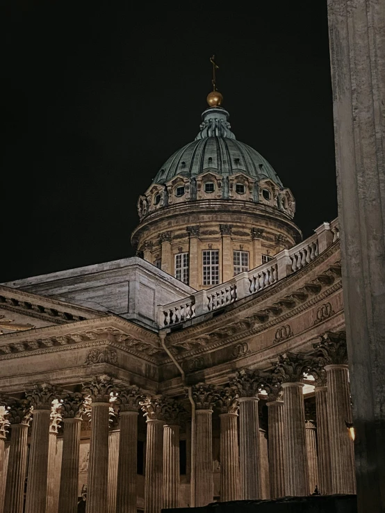 a building is lit up at night with people