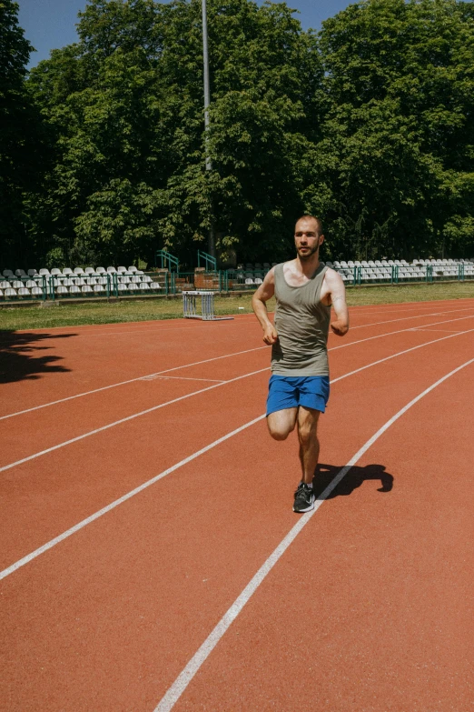 a man running on a red race track